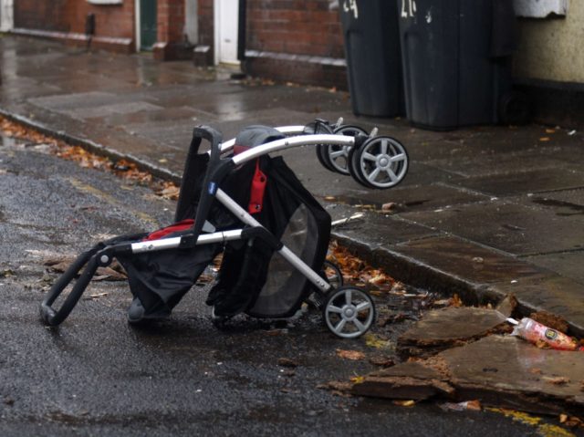 A discarded pushchair lies in the street in the Eastwood area of Rotherham, South Yorkshir