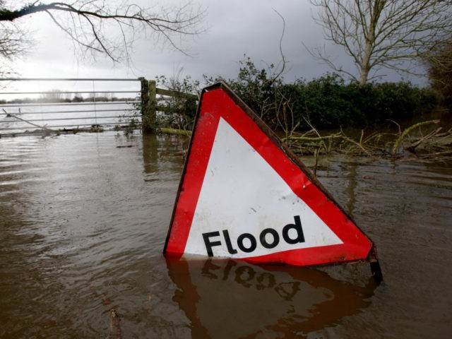 MOORLAND, UNITED KINGDOM - JANUARY 28: A flood sign is seen in flood waters surrounding f
