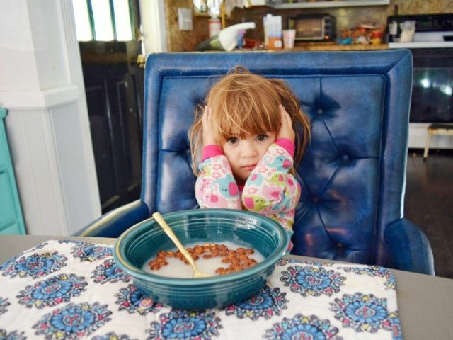 Little girl doesn't want to eat her breakfast