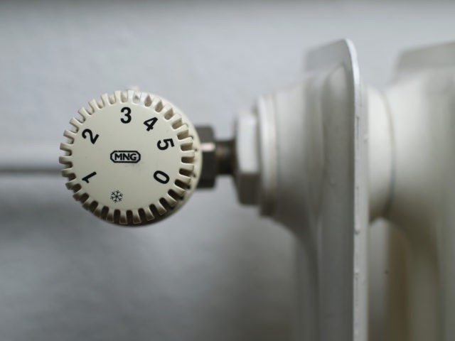 BERLIN, GERMANY - FEBRUARY 18: An older-model thermostat is seen attached to a heating radiator in an apartment on February 18, 2016 in Berlin, Germany. Consumers are expected to enjoy lower-than-average heating bills for this winter season due to the very late start of winter weather and the overall relatively …