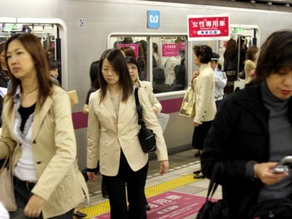 TOKYO, JAPAN - MAY 11: Female passengers come out from a "Women Only" carriage at a metro station May 11, 2005 in Tokyo, Japan. Nine private railways and subway trains operated by the Tokyo metropolitan government began running "Women Only" carriages during the morning hours in order to prevent railway …