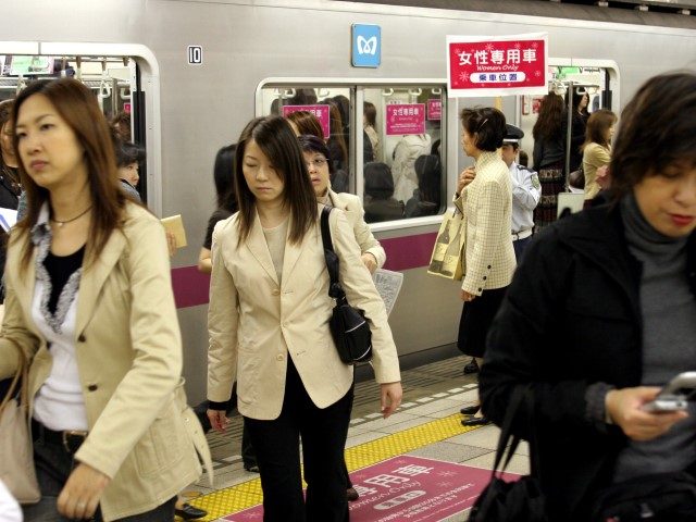 TOKYO, JAPAN - MAY 11: Female passengers come out from a "Women Only" carriage at a metro