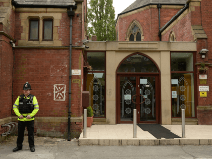 Police officers stand on duty outside a Didsbury Mosque in Didsbury, Manchester, northwest England, on May 24, 2017, as investigations continue into the May 22 terror attack at the Manchester Arena. Police on Tuesday named Salman Abedi -- reportedly British-born of Libyan descent -- as the suspect behind a suicide …