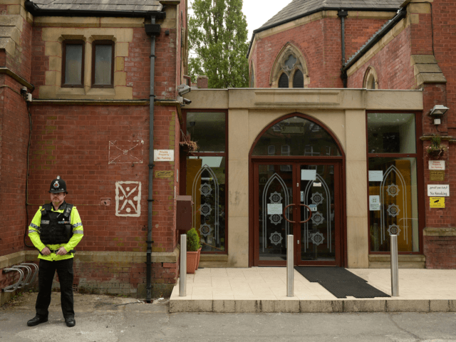 Police officers stand on duty outside a Didsbury Mosque in Didsbury, Manchester, northwest