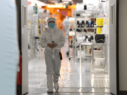 An engineer works in the clean room facilities at the LETI, a French research institute for electronics and information technologies founded by the French Alternative Energies and Atomic Energy Commission (CEA), on June 28, 2017 in Grenoble, central France, during the LETI Tech, Innovation Days. ?The LETI and Berlin-based Fraunhofer …