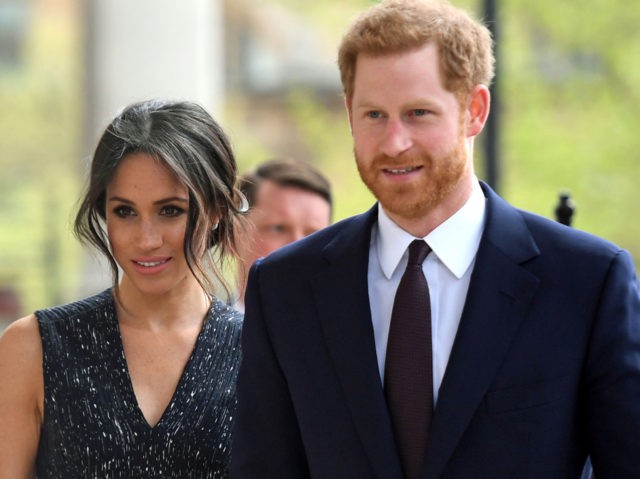 Britain's Prince Harry (R) and his US fiancee Meghan Markle arrive to attend a memori