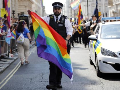 Police officers join supporters and members of the Lesbian, Gay, Bisexual and Transgender (LGBT) community taking part in the annual Pride Parade in London on July 7, 2018. (Photo by Tolga AKMEN / AFP) (Photo credit should read TOLGA AKMEN/AFP via Getty Images)