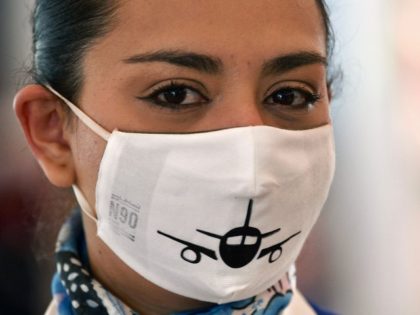 An airline employee wears a face mask as a preventive measure against the spread of COVID-19, at Quito's International Airport as Ecuador resumes domestic flights amid the novel coronavirus pandemic, on June 1, 2020. - Ecuador, severely affected by the coronavirus, resumed domestic commercial flights on Monday and will resume …