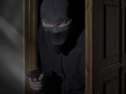 Home intruder with gun