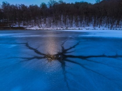 Icy pond at night