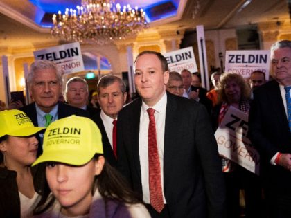 U.S. Rep. Lee Zeldin, center, walks to the stage before speaking to delegates and assembled party officials at the 2022 NYGOP Convention, Tuesday, March 1, 2022, in Garden City, N.Y. Republicans from across New York met Tuesday to choose their gubernatorial nominee to run against Gov. Kathy Hochul in November. …