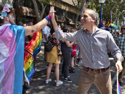 FILE - In this June 9, 2019, file photo, Los Angeles Mayor Eric Garcetti, right, greets a parade-goer while participating in the annual Los Angeles Pride Parade in West Hollywood, CA. Organizers have canceled the 2020 edition of LA Pride, one of California's largest gay and lesbian rights festivals, amid …