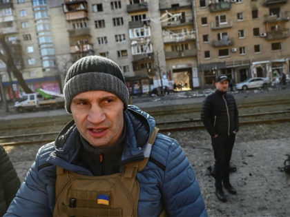 Kyiv's mayor Vitali Klitschko (C) walks in front of a destroyed apartment building, in Kyiv on March 14, 2022, on the 19th day of the Russian invasion of Ukraine. - Ukrainian Prime Minister Denys Chmygal asked the Council of Europe on March 14, 2022 for the "immediate expulsion" of Russia …