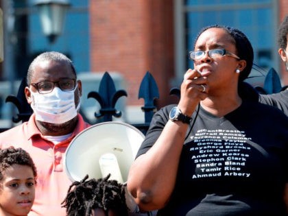 Protesters, including Eric Garner Jr., (R) gather at the State House as Monica Cannon-Grant(C), speaks during a Juneteenth protest and march in honor of Rayshard Brooks and other victims of Police Violence in Boston, Massachusetts on June 22, 2020. (Photo by Joseph Prezioso / AFP) (Photo by JOSEPH PREZIOSO/AFP via …