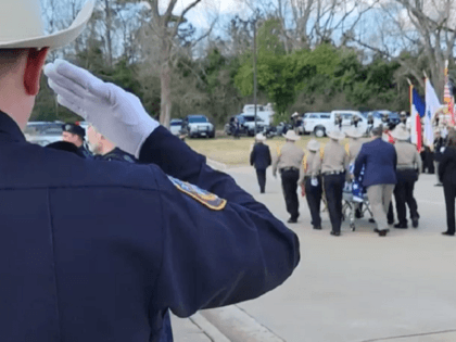 Law enforcement salutes the life of San Jacinto County Precinct 1 Constable's Deputy Neil Adams in Coldspring, Texas. (Bob Price/Breitbart Texas)