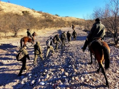Nogales Station Horse Patrol Unit agents apprehend a group of migrants in the Arizona dese