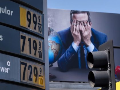 Gas prices are seen in front of a billboard advertising HBO's Last Week Tonight in Los Angeles, Monday, March 7, 2022. The price of regular gasoline broke $4 per gallon on average across the U.S. on Sunday for the first time since 2008.
