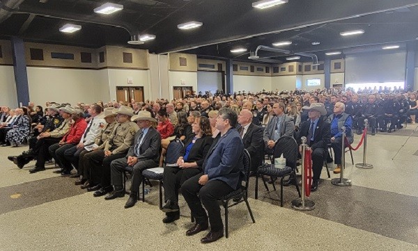 Congressman Kevin Brady joins the packed community center in Coldspring to honor Deputy Neil Adams. (Bob Price/Breitbart Texas)