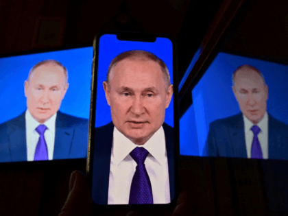 A live broadcast of Russian President Vladimir Putin's annual press conference is seen on a smartphone in Moscow on December 23, 2021. (Photo by Yuri KADOBNOV / AFP) (Photo by YURI KADOBNOV/AFP via Getty Images)
