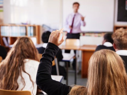 Female Student Raising Hand To Ask Question In Classroom. (monkeybusinessimages/iStock/Getty Images)