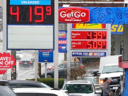 People pump gas at a Giant Eagle GetGo where a gallon of unleaded regular gas is $4.19.9, while at a neighboring Sunoco station, rear, a gallon of unleaded regular is $4.39.9, in Mount Lebanon, Pa., Monday, March 7, 2022. (AP Photo/Gene J. Puskar)