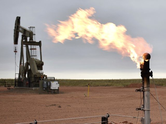 FILE - A flare burns excess natural gas at an oil well on Aug. 26, 2021, in Watford City,