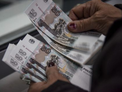 A pensioner counts Russian rubles after receiving a pension in rubles in Donetsk, eastern Ukraine, Wednesday, April 1, 2015. Russia-backed rebel authorities in eastern Ukraine have started paying pensions in Russian rubles. Yekaterina Matyushchenko, the finance minister in the Donetsk region's separatist government, said Wednesday that pension payments for March …