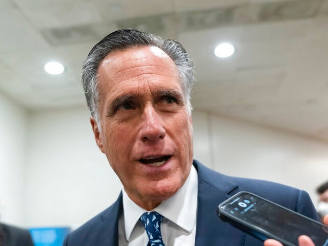 Sen. Mitt Romney, R-Utah, talks to reporters during votes, at the Capitol in Washington, T