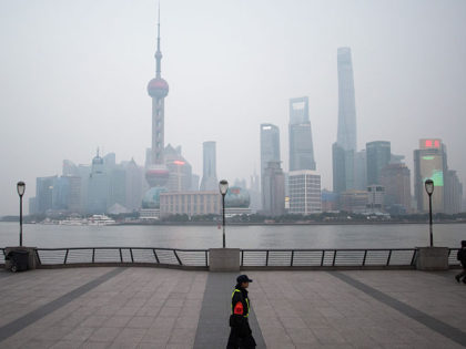 A security guard walks at the bund near the Huangpu river across the Pudong New Financial district, in Shanghai on January 18, 2016. China recorded its lowest growth in a quarter of a century in 2015, an AFP survey has forecast, projecting a further slowdown in the world's second-largest economy …