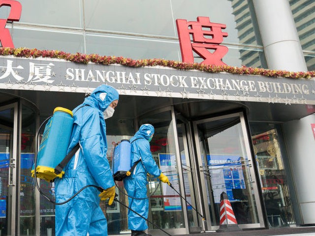 Medical workers spray antiseptic outside of the main gate of Shanghai Stock Exchange Building on February 03, 2020 in Shanghai, China. (Photo by Yifan Ding/Getty Images)