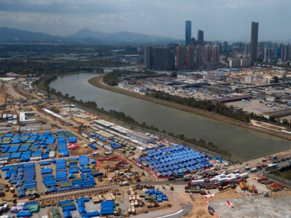An aerial view shows the construction site for COVID-19 isolation facilities and a temporary bridge linked between China's Shenzhen and Hong Kong's Lok Ma Chau, Friday, March 11, 2022. (AP Photo/Kin Cheung)