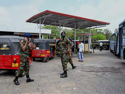 Soldiers guard a fuel station in Colombo on March 22, 2022. - Sri Lanka ordered troops to