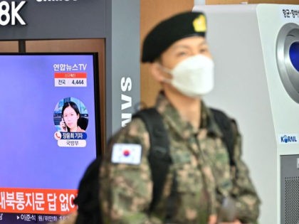 A South Korean soldier walks past a television news screen showing file footage of a North Korean missile test, at a railway station in Seoul on January 5, 2022, after North Korea fired what appeared to be a ballistic missile into the sea off its east coast according to the …