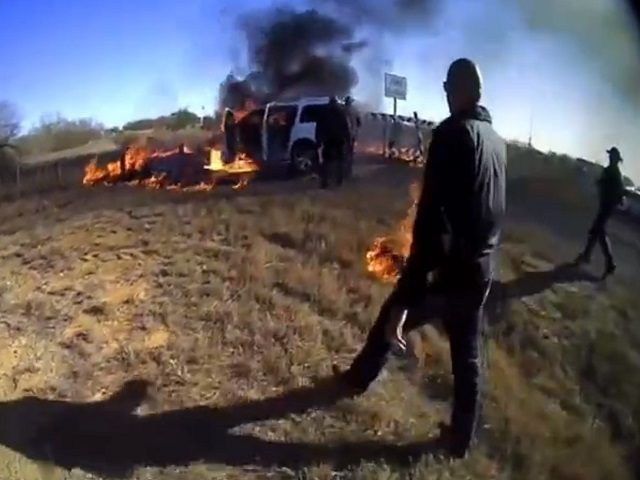Texas DPS troopers help Border Patrol agents rescue a migrant woman trapped in a smuggler's burning vehicle. (Texas DPS Body Cam)