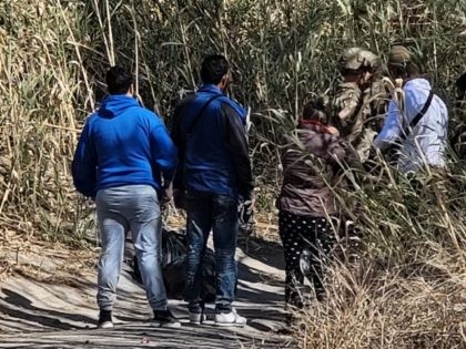 Texas National Guard soldiers help apprehend a group of migrants near Eagle Pass, Texas. (Bob Price/Breitbart Texas)