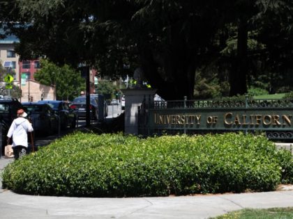 BERKELEY, CALIFORNIA - JULY 22: A pedestrian walks by a sign in front of the U.C. Berkeley campus on July 22, 2020, in Berkeley, California. U.C. Berkeley announced plans on Tuesday to move to online education for the start of the school's fall semester due to the coronavirus COVID-19 pandemic.