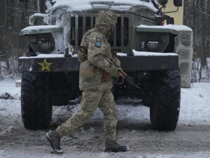 A Ukrainian serviceman walks by a deactivated Russian military multiple rocket launcher on the outskirts of Kharkiv, Ukraine, Friday, Feb. 25, 2022. Russian troops bore down on Ukraine's capital Friday, with gunfire and explosions resonating ever closer to the government quarter, in an invasion of a democratic country that has …