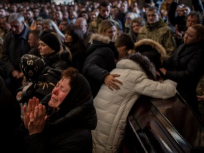 Relatives and friends attend a funeral ceremony for four of the Ukrainian military service