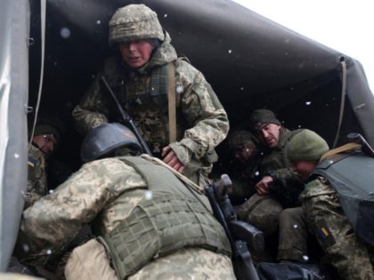 Servicemen of Ukrainian Military Forces move to their position prior to the battle with Russian troops and Russia-backed separatists in Luhansk region on March 8, 2022. - The number of refugees flooding across Ukraine's borders to escape towns devastated by shelling and air strikes passed two million, in Europe's fastest-growing …