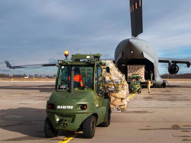 In this photo provided by Lithuanian Ministry of National Defense, Lithuania's servicemen load Stinger anti-aircraft systems, and body armor vests into military cargo plane, as part of the Lithuania's security assistance to Ukraine at the Siauliai airbase, some 230 km (144 miles) east of the capital Vilnius, Lithuania, Saturday, Feb. …
