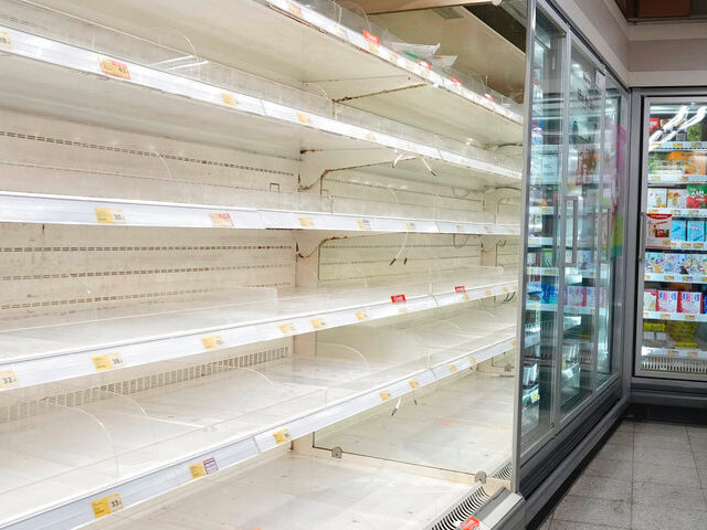 A woman wearing face mask looks at empty shelves as residents worry about a shortage of food and supplies, at a supermarket in Hong Kong Tuesday, March 1, 2022. Health authorities said the government could implement measures that may involve "asking people to stay at home," and that it remains …