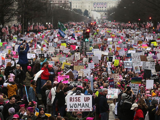 Protesters walk during the Women's March on Washington, with the U.S. Capitol in the backg