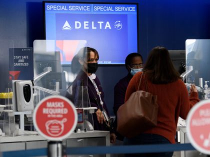 Passengers check bags for a Delta Air Lines, Inc. flight during the Covid-19 pandemic at Los Angeles International Airport (LAX) in Los Angeles, California, November 18, 2020. (Photo by Patrick FALLON / AFP) (Photo by PATRICK FALLON/AFP via Getty Images)