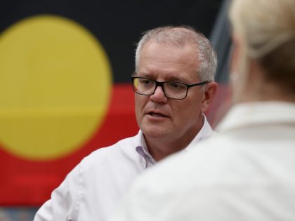 BRISBANE, AUSTRALIA - MARCH 10: Prime Minister Scott Morrison speaks at flooded Brisbane Basketball with an Indigenous flag in the background on March 10, 2022 in Brisbane, Australia. The Federal Government has announced plans to boost numbers in the Australian Defence Force. Morrison today announced the plan, which aims to …