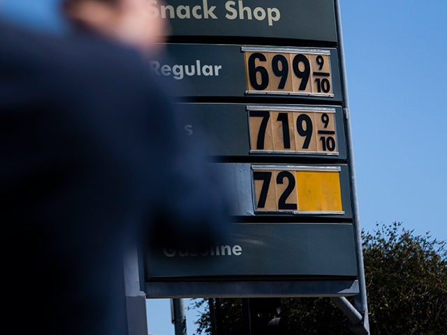 Martin Bruinsma, 65, takes pictures of gas prices in Los Angeles, Monday, March 7, 2022. The price of regular gasoline broke $4 per gallon on average across the U.S. on Sunday for the first time since 2008. (AP Photo/Jae C. Hong)