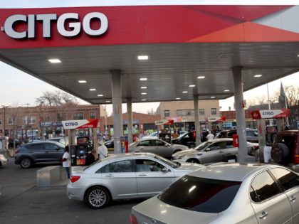 CHICAGO, ILLINOIS - MARCH 17: Motorists line up to receive free gas at a station in the Hu