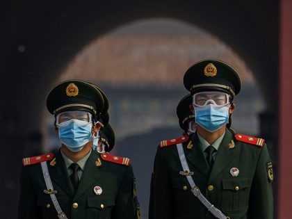 BEIJING, CHINA - MAY 01: Chinese paramilitary police wear protective masks as they guard the entrance to the Forbidden City as it re-opened to limited visitors for the May holiday, on May 1, 2020 in Beijing, China. Beijing lowered its risk level after more than three months Thursday in advance …
