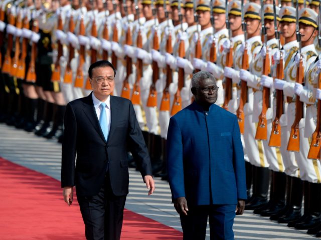 Solomon Islands Prime Minister Manasseh Sogavare (R) and Chinese Premier Li Keqiang inspec