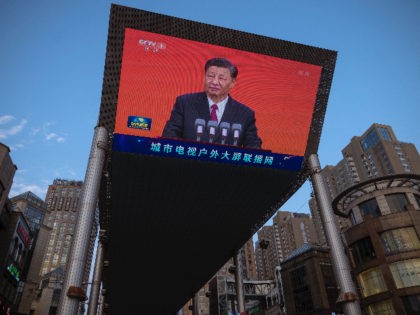 BEIJING, CHINA - JUNE 30: Chinese President Xi Jinping is seen on a big screen showing the Chinese state television CCTV evening news as the city gets ready for the upcoming centenary of the Communist Party of China on June 30, 2021 in Beijing, China. (Photo by Andrea Verdelli/Getty Images)
