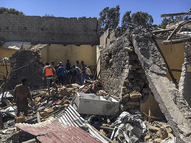 Residents sift through rubble from a destroyed building at the scene of an airstrike in Mekele, in the Tigray region of northern Ethiopia Thursday, Oct. 28, 2021. An Ethiopian government spokesman says a new airstrike has hit Mekele, targeting a site used by rival Tigray forces to make and repair …